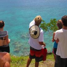 a group of people looking at the water