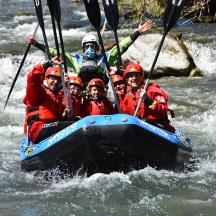 a group of people in a raft in a river