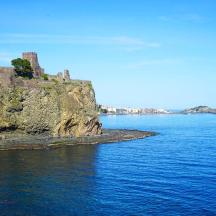 a castle on a rocky island in the water