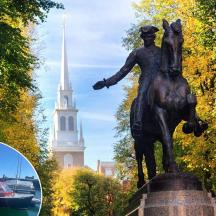 a statue of a man riding a horse next to a boat