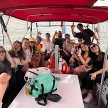 a group of people sitting on the back of a boat