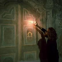 una dona dreta davant d'una porta amb llum