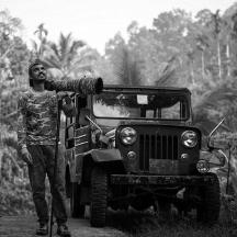 a man is standing next to a jeep