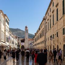 a group of people walking down a city street