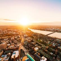 an aerial view of a city with the sun setting