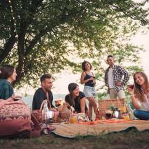 a group of people sitting around a picnic table