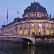 a large building with a bridge over a river