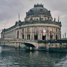 a large building with a bridge over a river