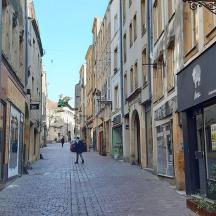 a person walking down a street in an alley