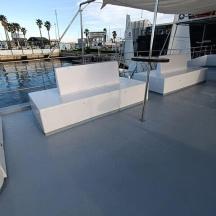 a boat with two white tables on the deck