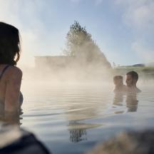 a group of people in the water at the geothermal spa