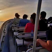 a group of people riding on a boat in the ocean