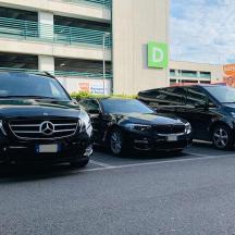 three cars parked in a parking lot in front of a building