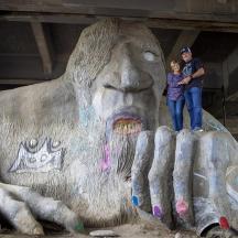 a man and a child standing next to a large statue