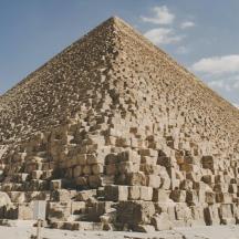a large pyramid with a blue sky in the background