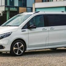 a white van parked in front of a building