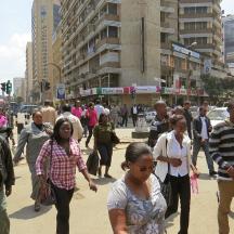 a group of people walking down a busy city street
