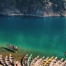 a group of boats in the water with people in them