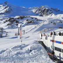 a snow covered mountain with people on a ski lift