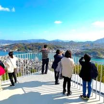 a group of people standing on top of a viewing deck
