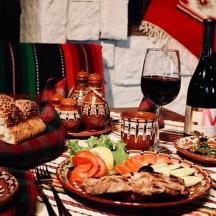 a table with plates of food and a glass of wine