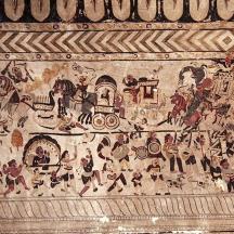 a wall with a painting of people on it