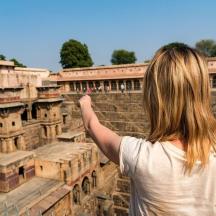 a woman is looking up at an old building