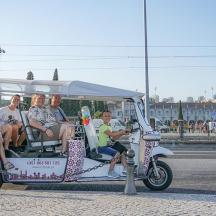 a group of people riding in a golf cart