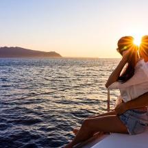 a man and woman sitting on a boat in the water