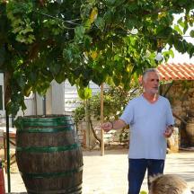 a man is standing next to a barrel