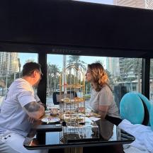 a man and woman sitting at a table in a restaurant