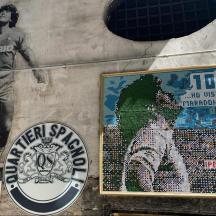 a wall with posters on the side of a building