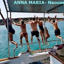 a group of people jumping off of a boat