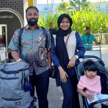 a man and a woman with a child in a stroller