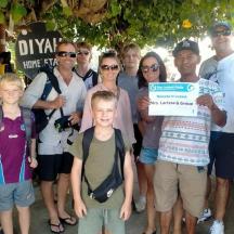 a group of people posing for a picture with a cheque