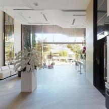 a hallway with a vase of flowers in a building