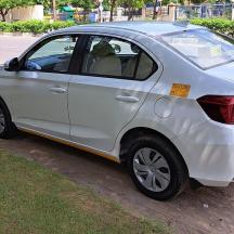 a white car parked on the side of a street