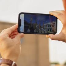a person taking a picture with a cell phone