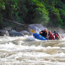 a group of people in a raft in a river