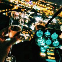 a person holding a glass of wine in a car