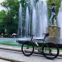a bike parked in front of a fountain