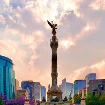 a statue on top of a tower in a city