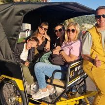 a group of people riding in a golf cart