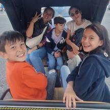 a group of people sitting on a roller coaster