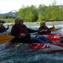 a group of people kayaking on a river