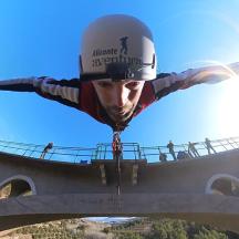 a person is flying over a bridge
