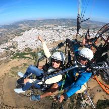 two people are riding in a parachute