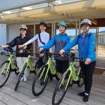 a group of people standing with bikes on a deck
