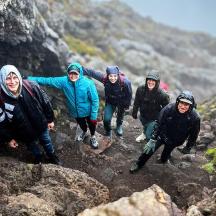 a group of people walking on a rocky mountain