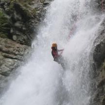 a person standing in front of a waterfall